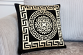 Black Greek key cushion close-up on sofa