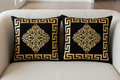 Two black and gold Greek key cushions on sofa